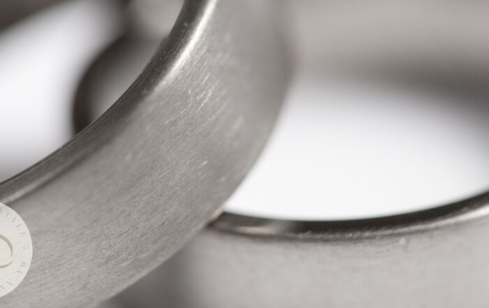 Close up image of two titanium wedding bands with a polish