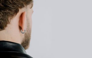 man wearing titanium hoop earrings