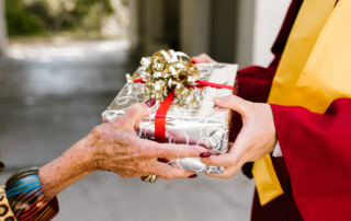 Someone giving a gift for graduation