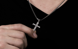 man wearing a titanium cross hypoallergenic jewelry