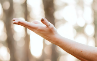 Side of left hand with a titanium ring on thumb