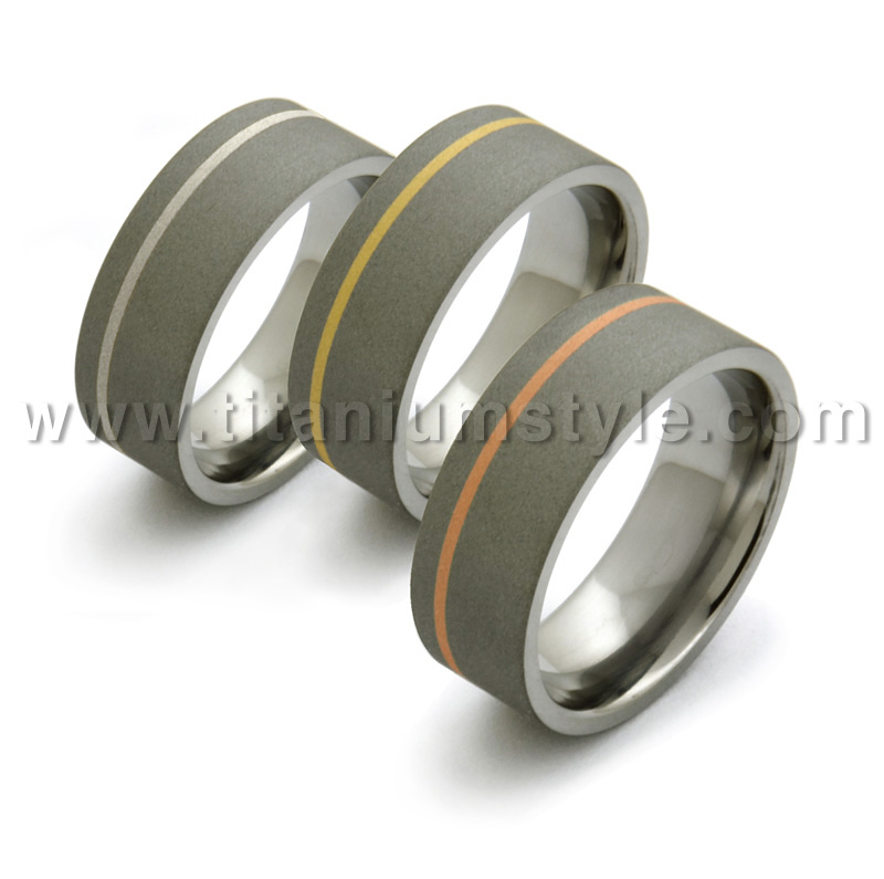 titanium ring with sandblast finish and 3 gold inlays